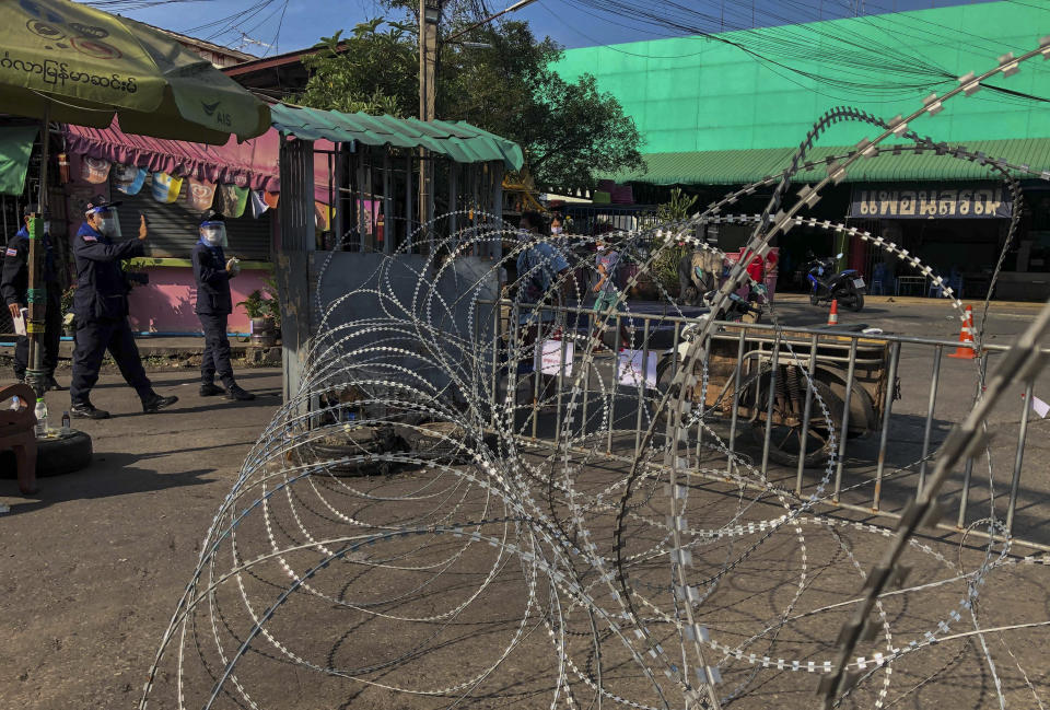 A shrimp market is closed and berbed-wired in Samut Sakhon, south of Bangkok, Thailand, Sunday, Dec. 20, 2020. Thailand reported more than 500 new coronavirus cases on Saturday, the highest daily tally in a country that had largely brought the pandemic under control. Health officials said the new cases are mostly migrant workers from Myanmar connected to the outbreak at the Klang Koong shrimp market in Samut Sakhon province. (AP Photo/ Jerry Harmer)