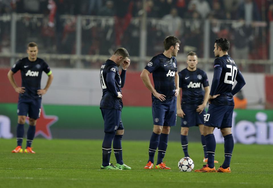 Manchester United's players react after Olympiakos' Alejandro Dominguez scored the opening goal of his team during their Champions League, round of 16, first leg soccer match at Georgios Karaiskakis stadium, in Piraeus port, near Athens, on Tuesday, Feb. 25, 2014. (AP Photo/Thanassis Stavrakis)