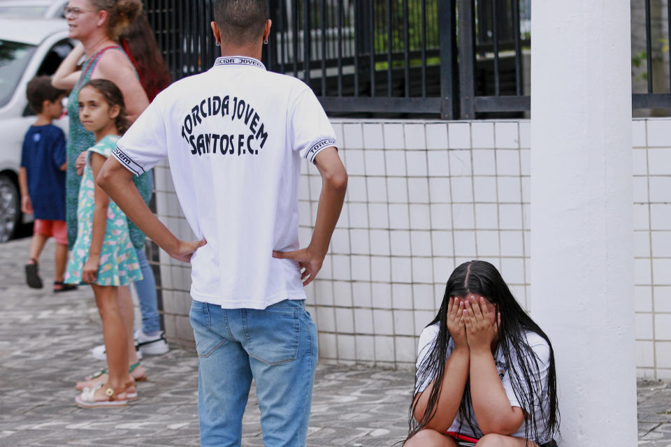 A fan of soccer star Pele cries after learning about his death, outside the Vila Belmiro stadium in Santos, Brazil, Thursday, Dec. 29, 2022. Edson Arantes do Nascimento, known as Pele, the Brazilian king of soccer who won a record three World Cups and became one of the most commanding sports figures of the last century, died in Sao Paulo. He was 82. (AP Photo/Fabricio Costa)