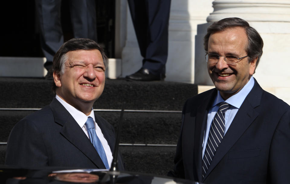 European Commission President Jose Manuel Barroso, left, looks to the sun as Greece's Prime Minister Antonis Samaras welcomes him at Maximos mansion in Athens, Thursday, July 26, 2012. International debt inspectors started new talks Thursday with the Greek government that will determine whether the country keeps receiving vital rescue loans or is forced to default and potentially leave the common European currency union. (AP Photo/Thanassis Stavrakis)