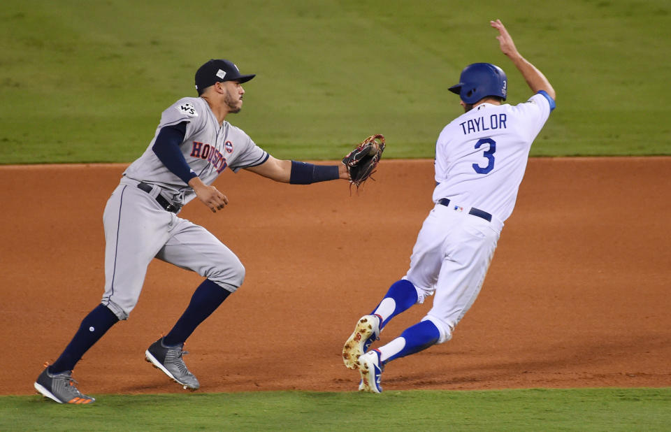 <p>Los Angeles Dodgers outfielder Chris Taylor (3) is tagged out by Houston Astros shortstop Carlos Correa (1) on a fielder’s choice in the fourth inning in game two of the 2017 World Series at Dodger Stadium. Mandatory Credit: Jayne Kamin-Oncea-USA TODAY Sports </p>