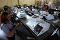 FILE - Electoral Court employees work on the final stage of sealing electronic voting machines in preparation for the general election run-off in Brasilia, Brazil, Oct. 19, 2022, ahead of the Oct. 30 second round vote. Valdemar Costa, president of the ruling Liberal Party, is calling on the electoral authority to annul votes cast on more than half of electronic voting machines used in the Oct. 30 election, citing a software bug. (AP Photo/Eraldo Peres, File)