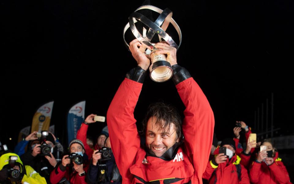 Frenchman Yannick Bestaven holds his trophy after winning the Vendee Globe solo round-the-world sailing race - Loic Venance /AFP