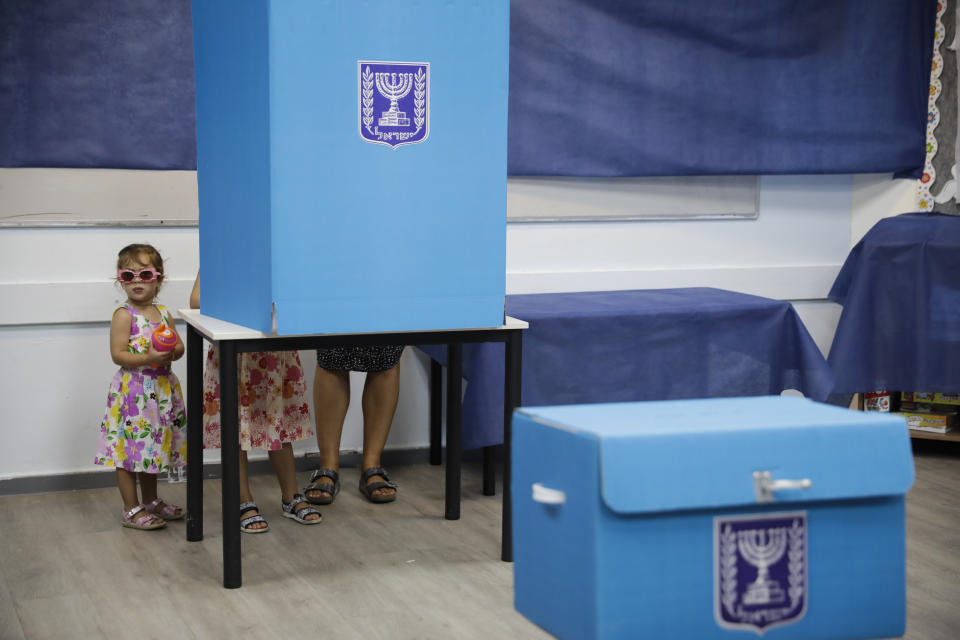 A woman votes at a polling station in Rosh Haayin, Israel, Tuesday, Sept. 17, 2019. Israelis began voting Tuesday in an unprecedented repeat election that will decide whether longtime Prime Minister Benjamin Netanyahu stays in power despite a looming indictment on corruption charges. (AP Photo/Sebastian Scheiner)