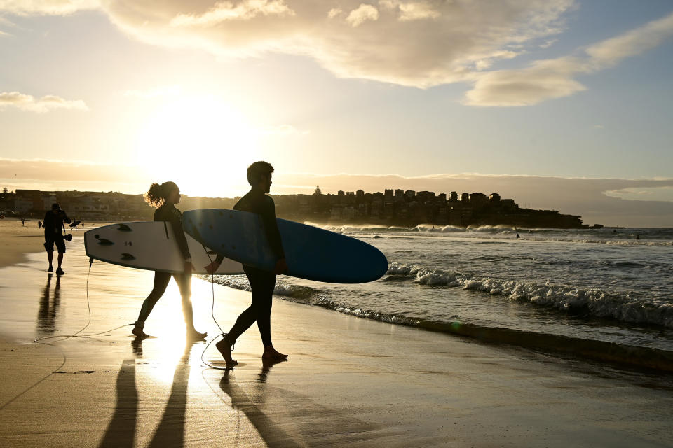 Surfers return to Bondi beach after coronavirus restrictions are llifted.