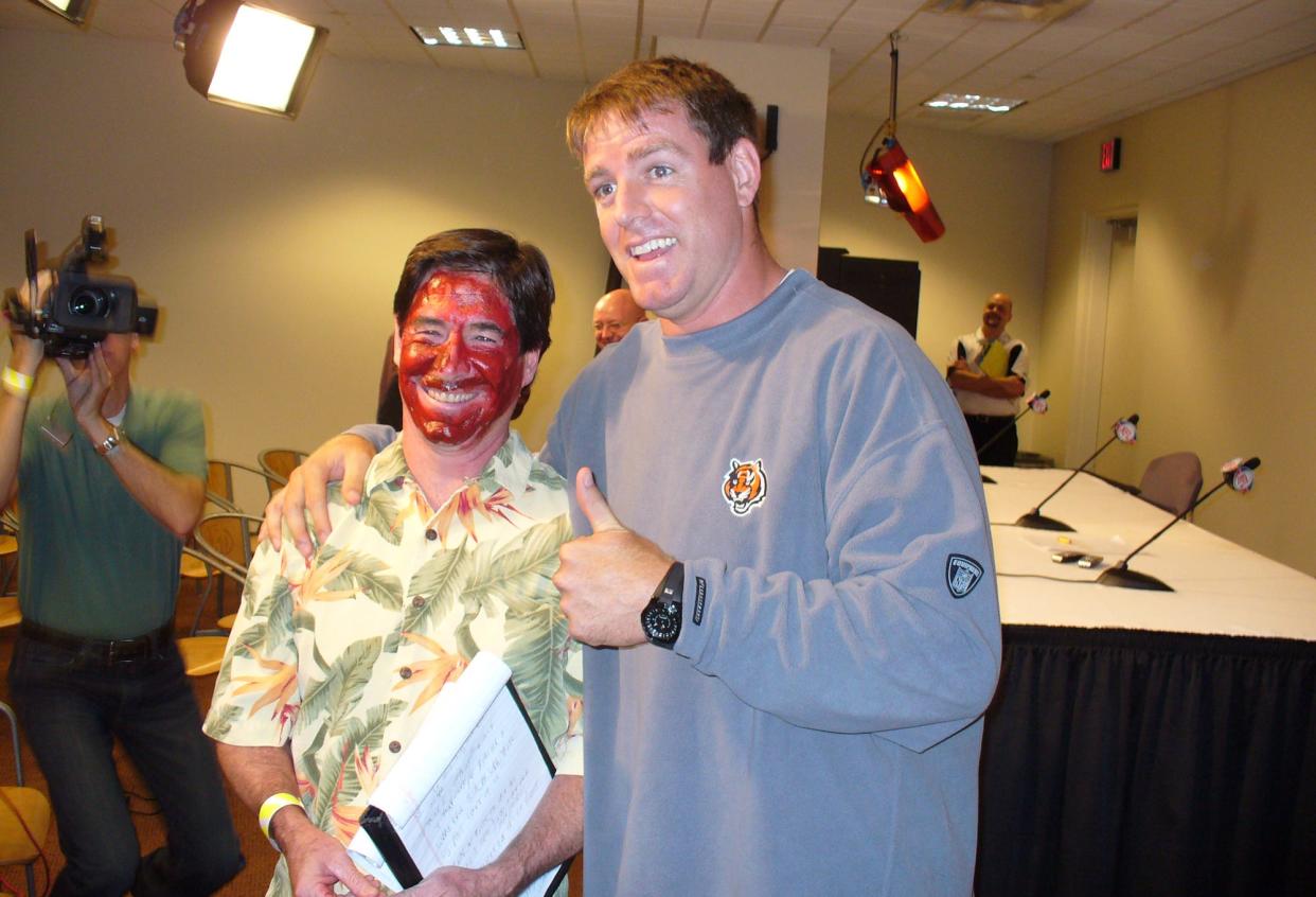 Enquirer columnist Paul Daugherty, wearing face paint, settles a bet with Bengals quarterback Carson Palmer In September 2008.