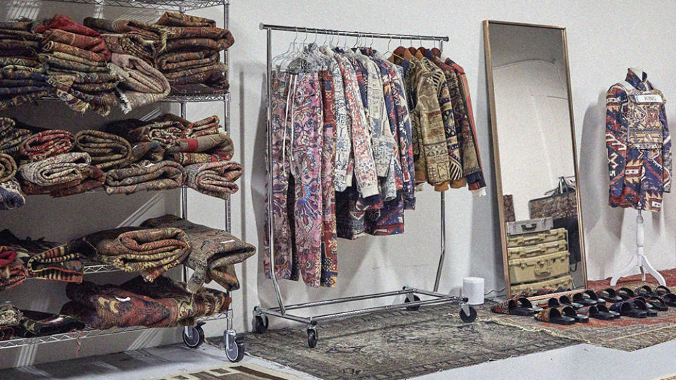 An assortment of rugs and clothing at King Kennedy Rugs' LA showroom.