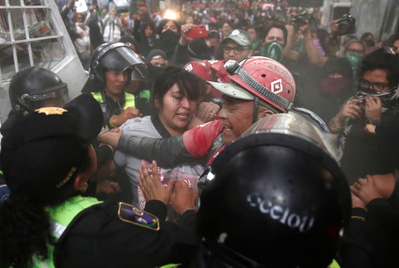 People take part in a protest against gender-based violence in downtown of Mexico City