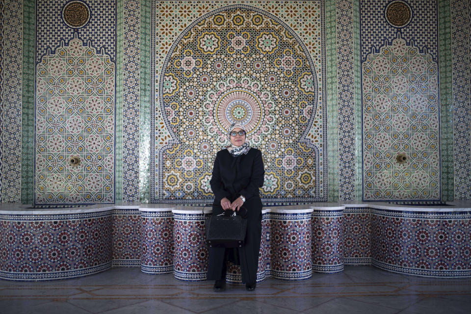 Aziza Moufid, 40, a female Muslim religious guide, or mourchida, poses for a portrait in Lalla Soukaina mosque, named after the daughter of the late King Hassan II, in Hay Riad neighborhood of Rabat, Morocco, Tuesday, Nov. 9, 2021. During the pandemic, Moufid has been using WhatsApp to explain sayings of the Prophet Muhammad to children, to help women learning to memorize and recite the Quran and to counsel teenage girls. (AP Photo/Mosa'ab Elshamy)