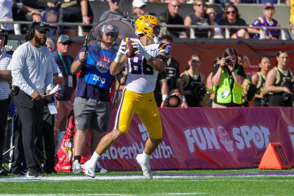 Jan 2, 2023; Orlando, FL, USA; LSU Tigers tight end Mason Taylor (86) catches a pass against the Purdue Boilermakers during the second quarter at Camping World Stadium. Mandatory Credit: Mike Watters-USA TODAY Sports