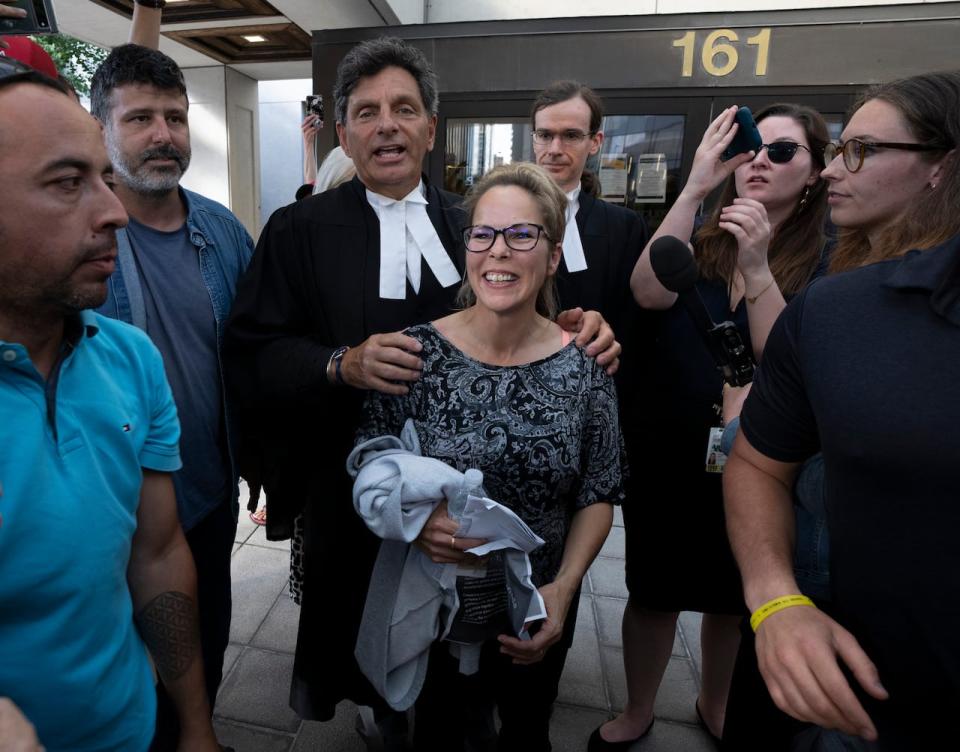 Freedom Convoy organizer Tamara Lich smiles as she stands with her lawyer Lawrence Greenspon outside the Ottawa Courthouse after being released from jail July 26, 2022.