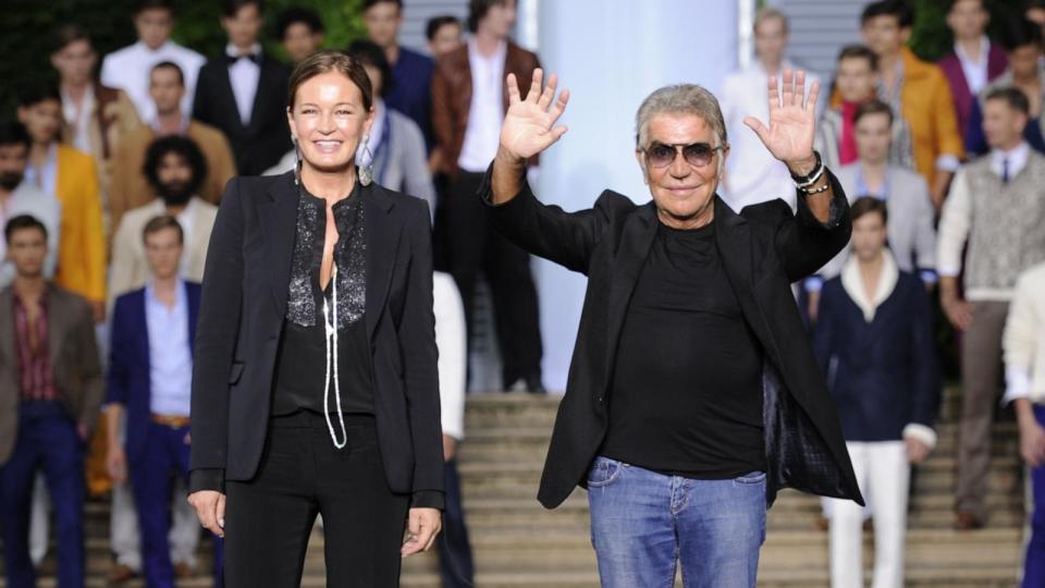 PHOTO: Fashion designer Roberto Cavalli and his wife Eva acknowledge the audience after the Roberto Cavalli Spring-Summer 2012 Menswear collection, June 18, 2011, during the Men's fashion week in Milan.  (Olivier Morin/AFP via Getty Images)