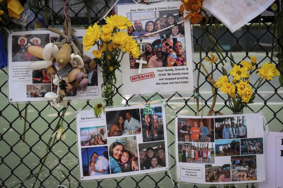 FILE - In this Tuesday, July 6, 2021, file photo, a memorial for the Guara family is posted on a fence near the Champlain Towers South, in Surfside, Fla. Recovery crews at the Florida condominium collapse are cataloging all personal possessions found in the rubble in hopes of returning them to families of the dead or survivors. (Carl Juste/Miami Herald via AP, File)