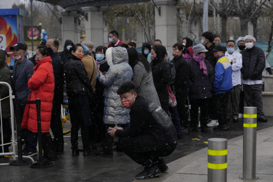 Residents line up for COVID-19 test as snow falls on Thursday, March 17, 2022, in Beijing. A fast-spreading variant known as "stealth omicron" is testing China's zero-tolerance strategy, which had kept the virus at bay since the deadly initial outbreak in the city of Wuhan in early 2020. (AP Photo/Ng Han Guan)