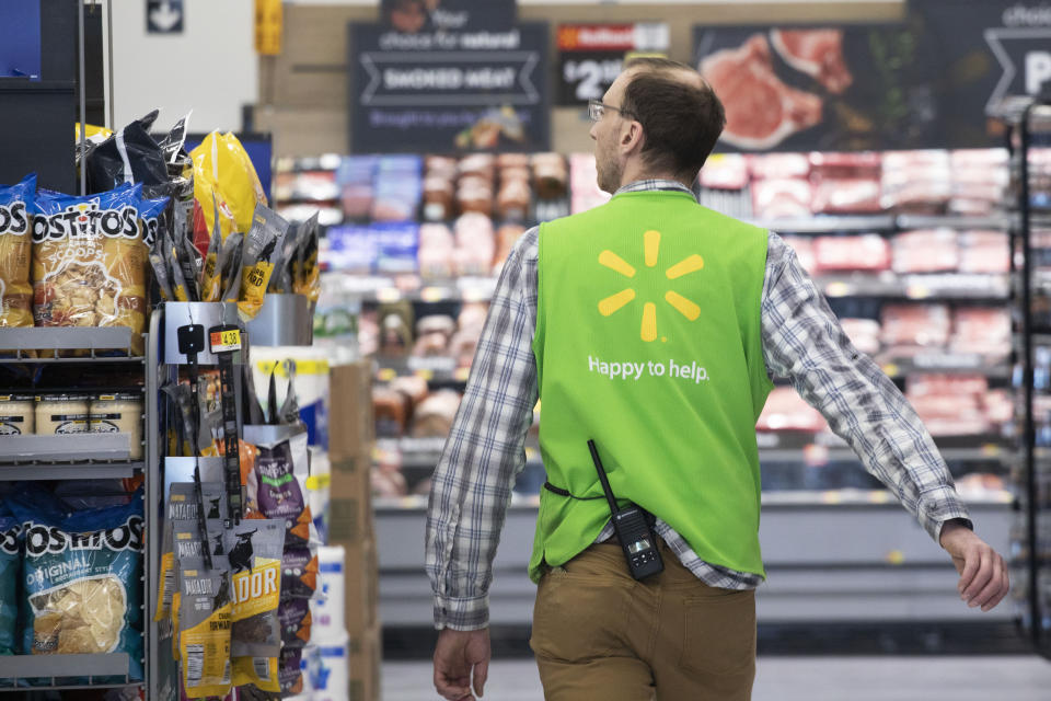 FILE - In this April 24, 2019, file photo a Walmart associate works at a Walmart Neighborhood Market in Levittown, N.Y. Walmart Inc. reports financial results Thursday, Aug. 15. (AP Photo/Mark Lennihan, File)