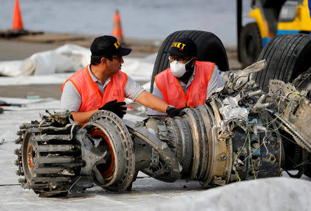 FILE PHOTO: Indonesian National Transportation Safety Commission (KNKT) officials examine a turbine engine from the Lion Air flight JT610 at Tanjung Priok port in Jakarta, Indonesia, November 4, 2018. REUTERS/Beawiharta/File Photo