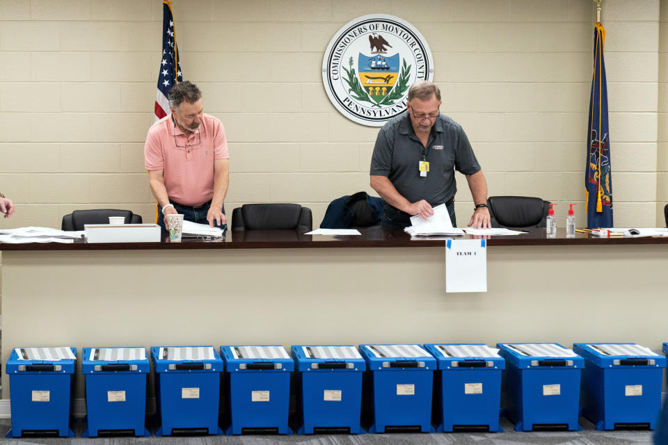 Election workers perform a recount of ballots from the recent primary election at the Montour County administration center in Danville, Pa., Friday, May 27, 2022. (AP Photo/Matt Rourke)