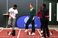 Britain's Catherine, Duchess of Cambridge, (C) prepares to race against sprinter Emmanuel Oyinbo-Coker (L) and heptathlete Jessica Ennis-Hill (R) on the running track with starting blocks during a SportsAid event at the London Stadium in east London on February 26, 2020. (Photo by Yui Mok / POOL / AFP) (Photo by YUI MOK/POOL/AFP via Getty Images)