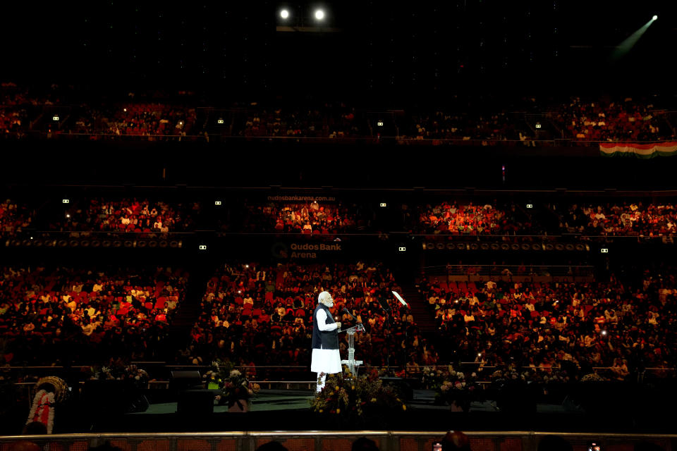 Indian Prime Minister Narendra Modi stands on the stage as he delivers his speech during an Indian community event at Qudos Bank Arena in Sydney, Australia, Tuesday, May 23, 2023. Modi has arrived in Sydney for his second Australian visit as India's prime minister and told local media he wants closer bilateral defense and security ties as China's influence in the Indo-Pacific region grows. (AP Photo/Mark Baker)