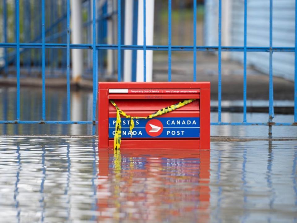 A partially flooded Canada Post mail box in the Gatineau, Que. region in May 2023. The company's revenue has been declining for the last six years and says its current financial challenges are 