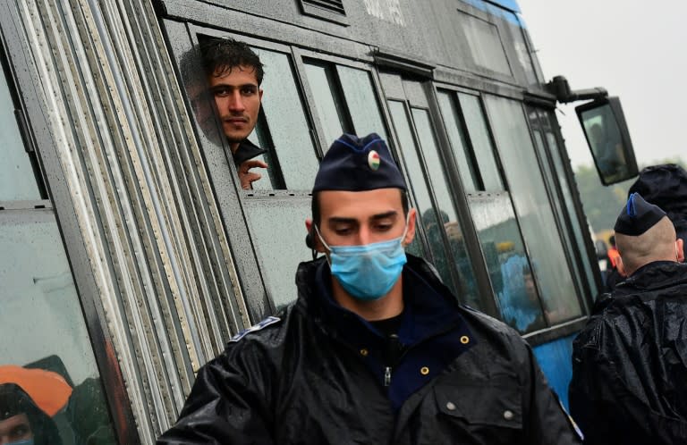 A migrant looks out of a bus window at the Hungarian-Serbian border near Roszke on September 10, 2015