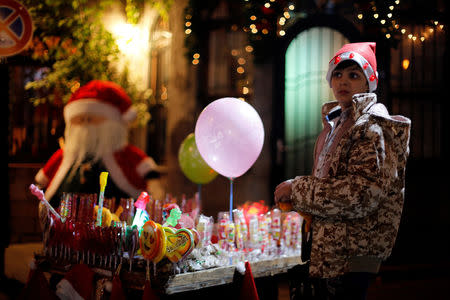 A boy sells sweets in the ancient quarter of Bab-Sharqi in Damascus, Syria December 15, 2018. Picture taken December 15, 2018. REUTERS/Omar Sanadiki