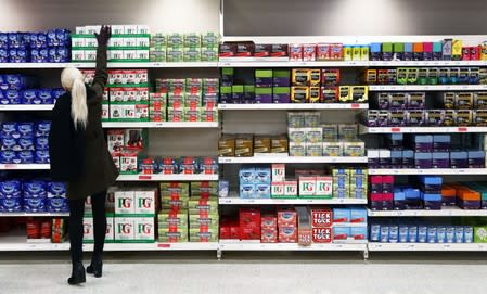 A shopper reaches for a box of tea in a supermarket in London