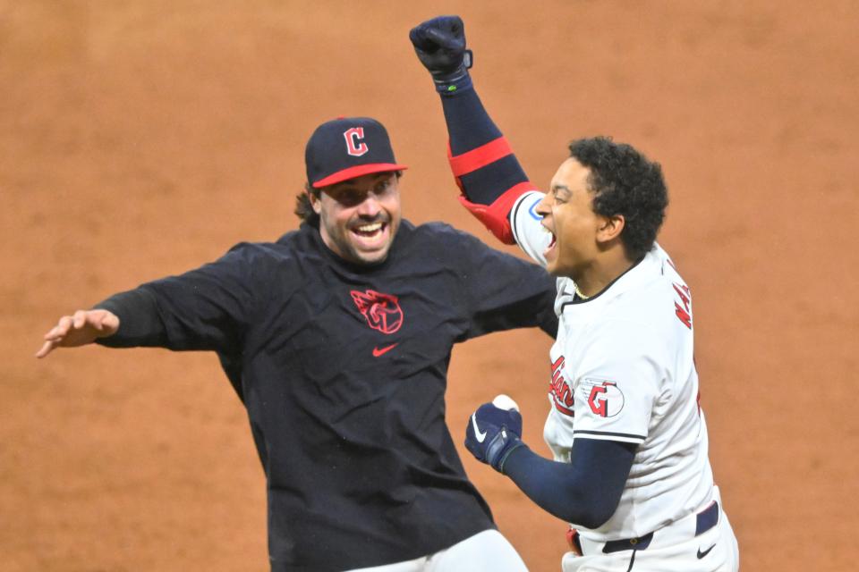 Guardians catcher Bo Naylor (right) celebrates his game-winning single with catcher Austin Hedges after a 10-inning win against the Chicago White Sox, April 10, 2024, in Cleveland.