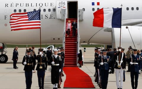 Emmanuel Macron holds hands with wife Brigitte Macron as they arrive at Andrews Air Force Base - Credit: AP Photo/Jacquelyn Martin