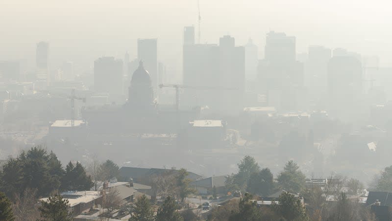 Smog settles over Salt Lake City on Sunday, Dec. 31, 2023. Utah is struggling to meet air quality standards set by the Environmental Protection Agency, Bryce Bird, director of Utah’s Division of Air Quality, said Wednesday.