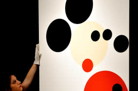 File photo dated 7/2/2014 of an employee hangs the Damien Hirst inspired Mickey Mouse which is to be auctioned tonight in the 'Post war and contemporary art evening auction' to be held at Christie's in central London. PRESS ASSOCIATION Photo. Issue date: Thursday February 13, 2014. See PA story SALE Mickey. Photo credit should read: John Stillwell/PA Wire