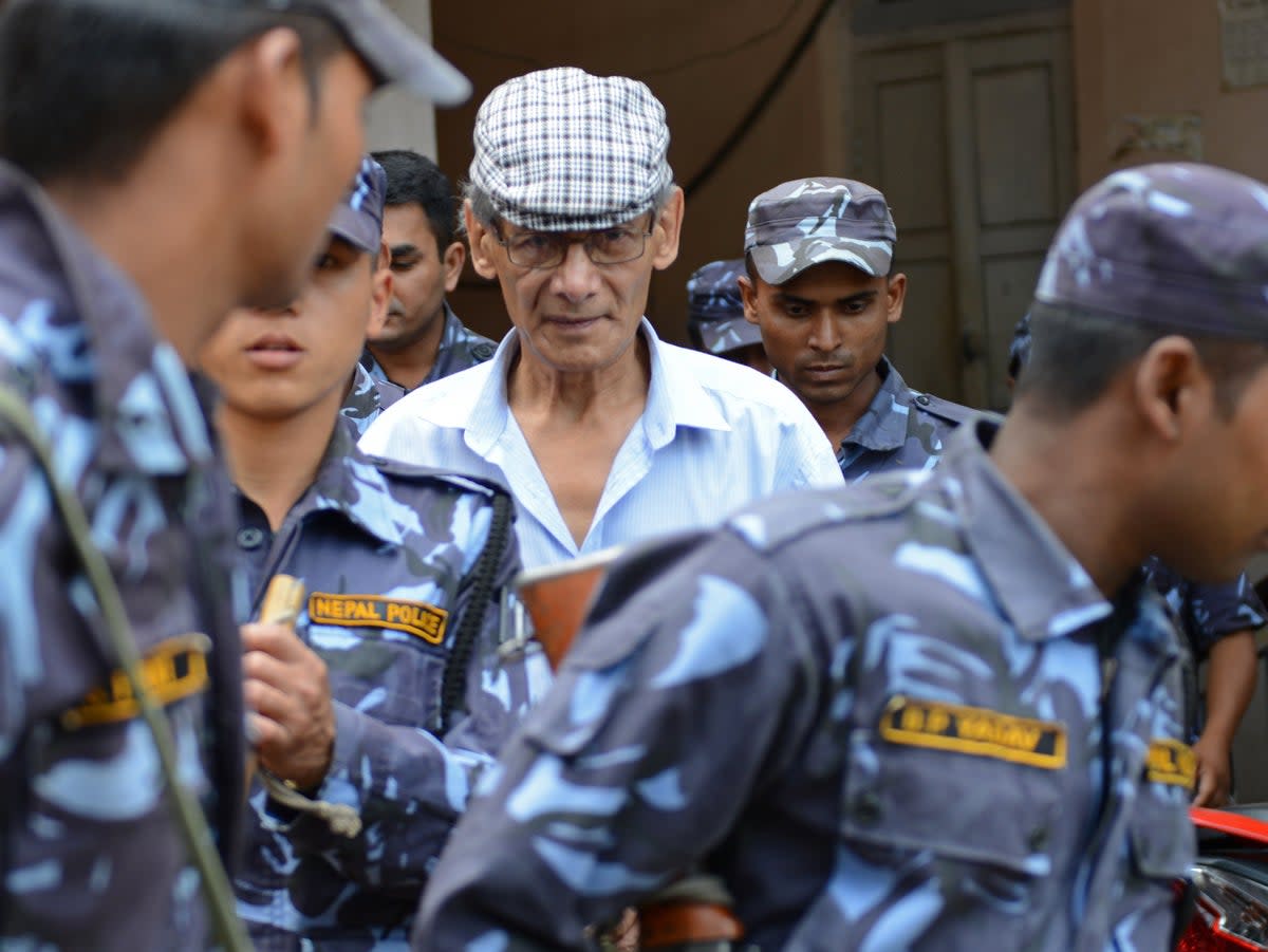 French serial killer Charles Sobhraj (centre) is escorted by Nepalese police in 2014  (AFP via Getty Images)