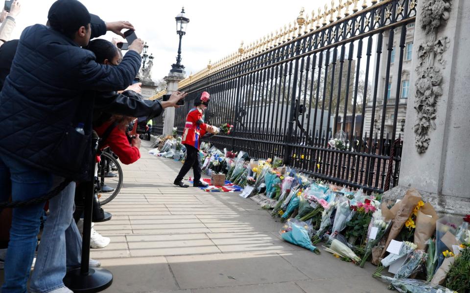 Flowers left outside Buckingham Palace on Friday - Alastair Grant /AP