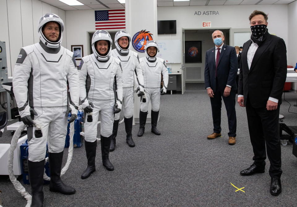 SpaceX CEO and founder Elon Musk and NASA acting administrator Steve Jurczyk visit with Crew-2, ESA astronaut Thomas Pesquet of France, NASA astronaut Megan McArthur, NASA astronaut Shane Kimbrough and JAXA astronaut Akihiko Hoshide of Japan inside the crew suit-up room, before the boarding of the SpaceX Falcon 9 rocket with the Crew Dragon capsule bound for the International Space Station in Cape Canaveral, Florida, U.S., April 23, 2021. Picture taken April 23, 2021.  NASA/Kim Shiflett/Handout via REUTERS.   MANDATORY CREDIT. THIS IMAGE HAS BEEN SUPPLIED BY A THIRD PARTY.