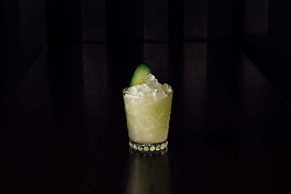 a glass with a lime in it