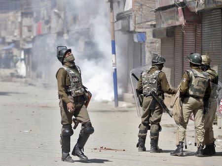 Indian security personnel stand guard on a street during a demonstration by Kashmiri protesters against the plan to resettle Hindus, in Srinagar April 10, 2015. REUTERS/Danish Ismail