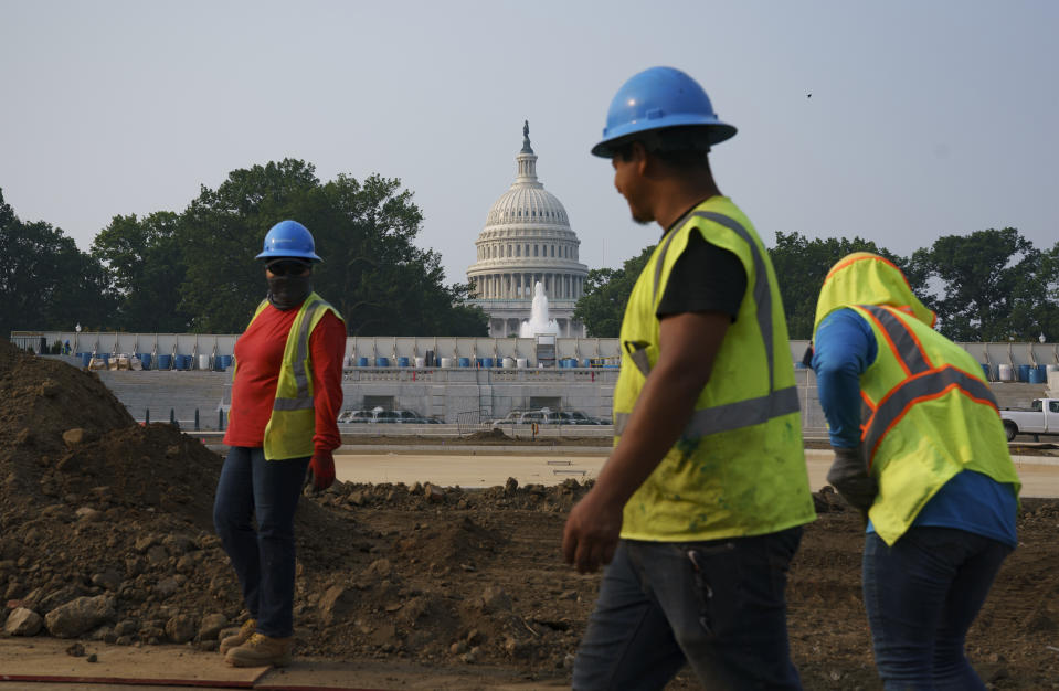 Workers repair a park near the Capitol in Washington, Wednesday, July 21, 2021. About 8 in 10 Americans favor plans to increase funding for roads, bridges and ports and for pipes that supply drinking water. But a new poll from The Associated Press-NORC Center for Public Affairs Research shows that’s about as far as Democrats and Republicans intersect on infrastructure. P (AP Photo/J. Scott Applewhite)