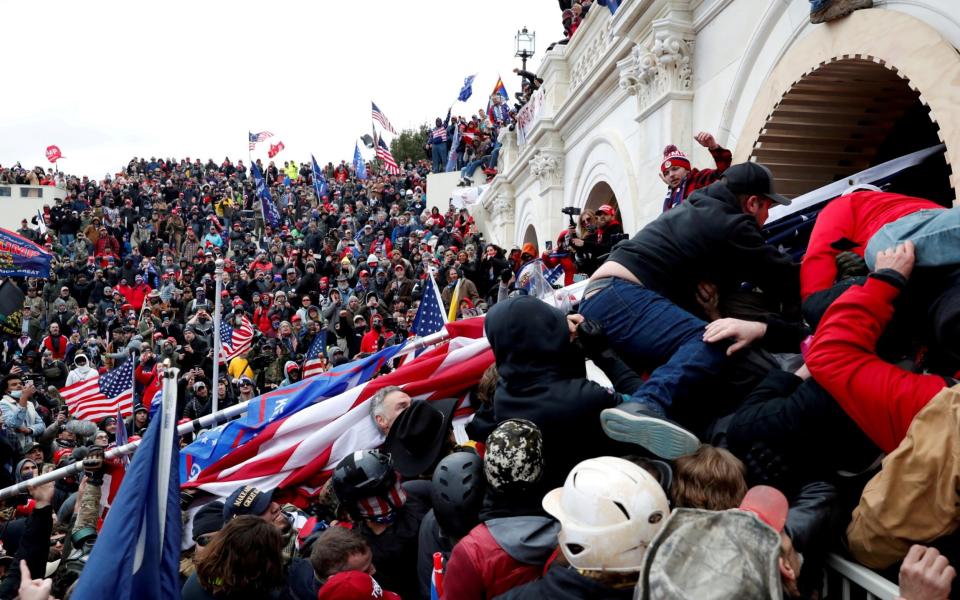 Pro-Trump protesters storm into the U.S. Capitol during clashes with police, during a rally to contest the certification of the 2020 U.S. presidential election results  - Shannon Stapleton/Reuters