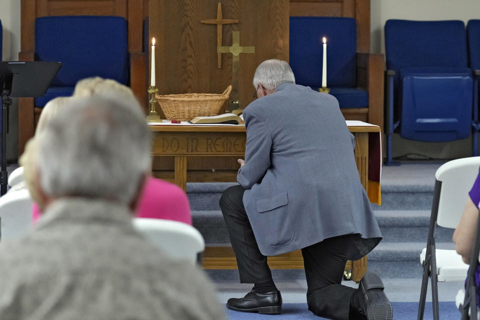 The Rev. Bill Farmer prays at the altar with the congregation at the Grace Methodist Church Sunday, May 14, 2023, in Homosassa Springs, Fla. Thousands of United Methodist congregations have been voting on whether to stay or quit one of the nation’s largest denominations amid intractable debates over theology and the role of LGBTQ people. (AP Photo/Chris O'Meara)