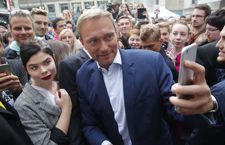 Leader of Germany's Free Democrats (FDP) Christian Lindner takes a selfie during the final campaign rally in Duesseldorf, Germany, September 23, 2017. REUTERS/Wolfgang Rattay