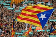 Protesters wave pro-independence Catalan Estelada flags during a demonstration in Barcelona on October 21, 2017