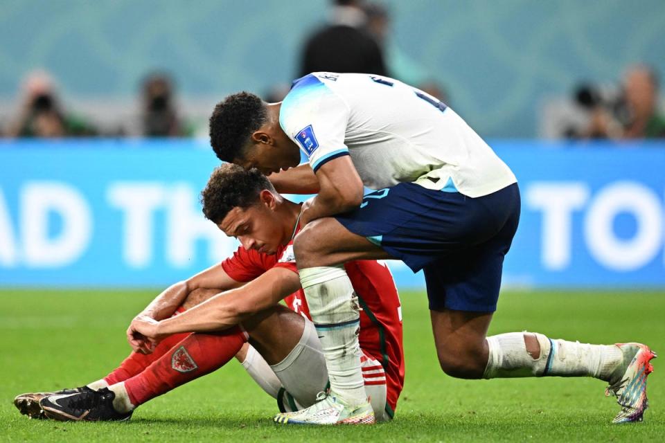 Bellingham comforts Ethan Ampadu after the match (AFP/Getty)