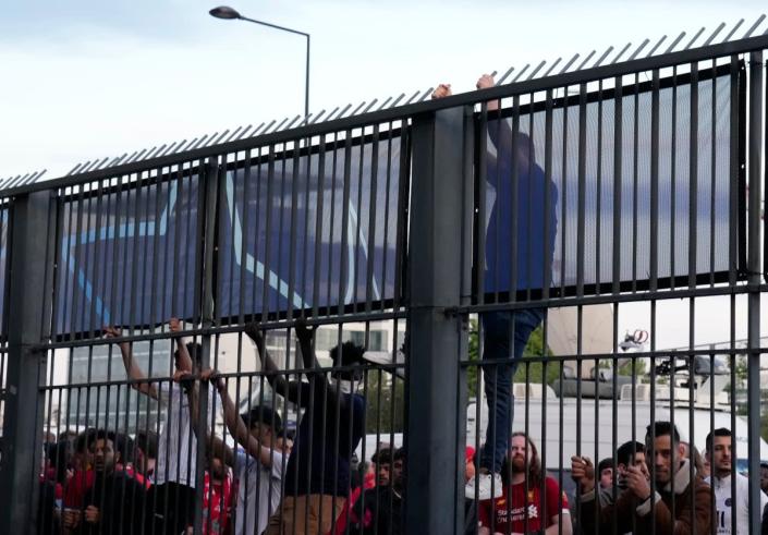 Some fans were spotted trying to climb the security fence (AP)