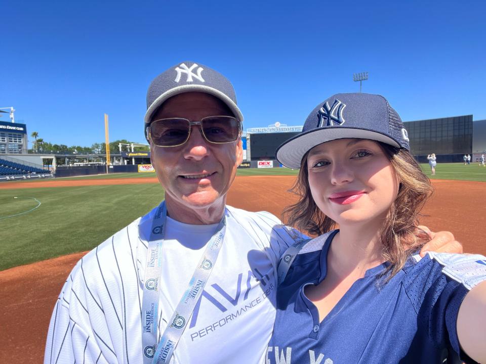 The author and TK posing on the Yankees field, Lucia Bailey, "I Drained My Savings For The Yankee Inside Experience and It Was a Huge Disappointment. "