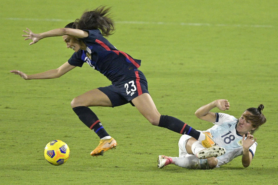 CORRECTS DATE United States forward Christen Press (23) and Argentina defender Romina Nunez (18) collide while going for a ball during the first half of a SheBelieves Cup women's soccer match, Wednesday, Feb. 24, 2021, in Orlando, Fla. (AP Photo/Phelan M. Ebenhack)