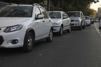 Cars line up outside a gas station in Tehran, Iran Wednesday, Oct. 27, 2021. Iran's President Ebrahim Raisi said Wednesday that a cyberattack which paralyzed every gas station in the Islamic Republic was designed to get "people angry by creating disorder and disruption." Long lines snaked around the pumps a day after the incident began as some stations began selling fuel again although at higher, unsubsidized prices. (AP Photo/Vahid Salemi)