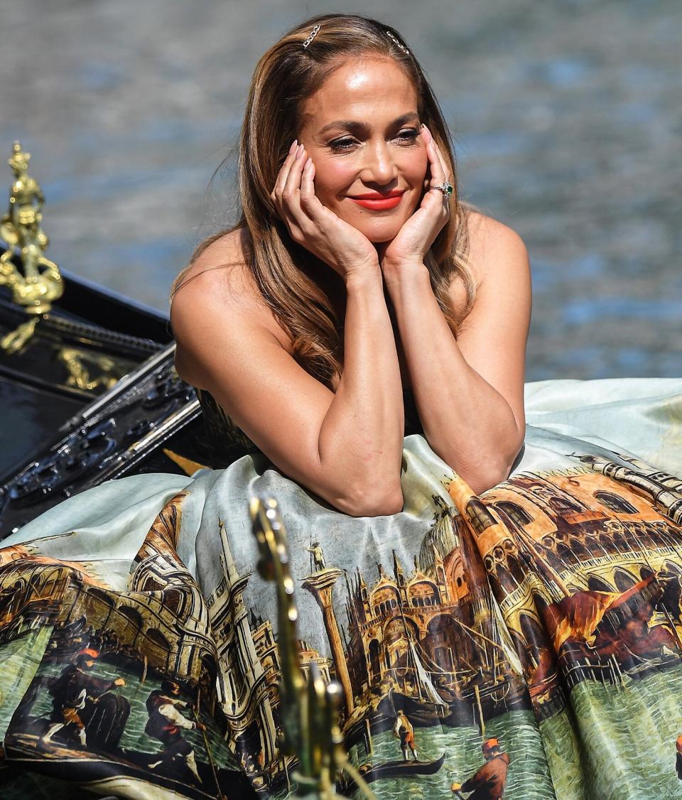 09/11/2021 Jennifer Lopez is seen on a gondola in Venice, Italy. The 52 year old took to the water for a stunning photoshoot wearing a Dolce &amp; Gabbana strapless tulle ballgown.