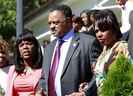 (L-R) U.S. Representative Terri Sewell, civil rights activist Reverend Jesse Jackson and Baptist minister Bernice King exit the church to attend the bell ringing and laying of the wreath at 10:22 at 16th Street Baptist Church in Birmingham, Alabama September 15, 2013. REUTERS/Marvin Gentry