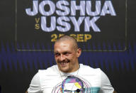 Oleksandr Usyk of Ukraine smiles during a press conference after winning the WBA (Super), WBO and IBF boxing title bout against Anthony Joshua of Britain at the Tottenham Hotspur Stadium in London Saturday Sept. 25, 2021. (Nick Potts/PA via AP)