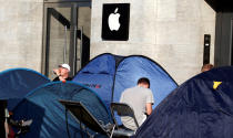 Customers wait beside their tents outside an Apple store to buy the newly released Apple iPhone 7 at Kurfuerstendamm boulevard in Berlin, Germany, September 12, 2016. REUTERS/Fabrizio Bensch